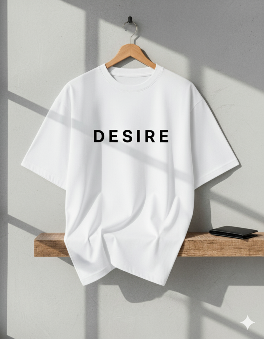 White t-shirt with 'DESIRE' text on a wooden hanger against a gray wall.