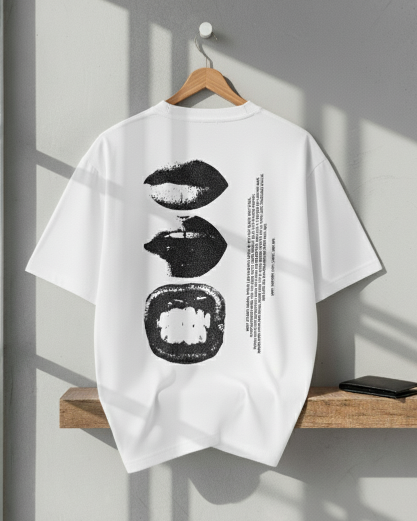 White t-shirt with black graphics on a wooden hanger against a gray wall.